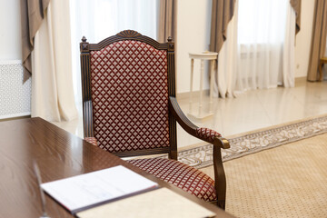 Standard wedding registration hall in Moscow. A red armchair in the Empire style at the wooden...