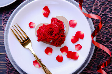 Valentine's Day Serving. Beautiful table setting with scarlet roses