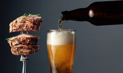 Beer and grilled ribeye beef steak. - Powered by Adobe