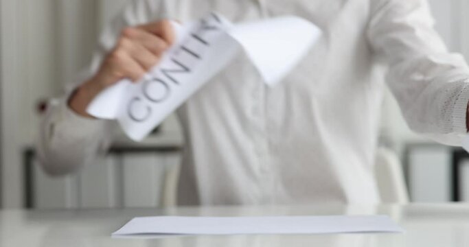 Business woman tearing contract at office closeup