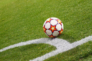 Fototapeta na wymiar A soccer ball sits on the pitch near by corner area