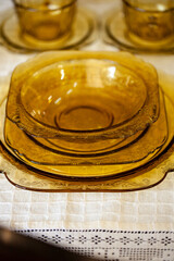 table setting with an antique glass service with a filigree pattern. yellow glass service in the interior. vintage service close-up