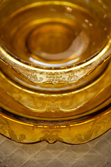 table setting with an antique glass service with a filigree pattern. yellow glass service in the interior. vintage service close-up