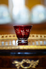 beautiful antique glass of red color in the interior of the renaissance style. antique glass with floral pattern