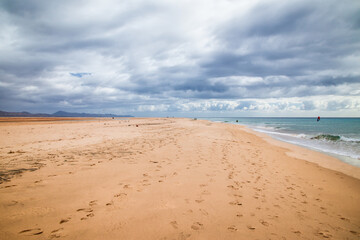 Fototapeta na wymiar mystic windy and cloudy beach fuerteventura