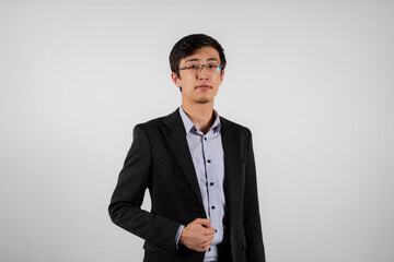 Portrait of young asian man wearing glasses, black office jacket and blue shirt