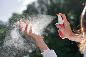 hand spraying flacon on the palm. spray droplets frozen in the air shot at a short shutter speed. High quality photo