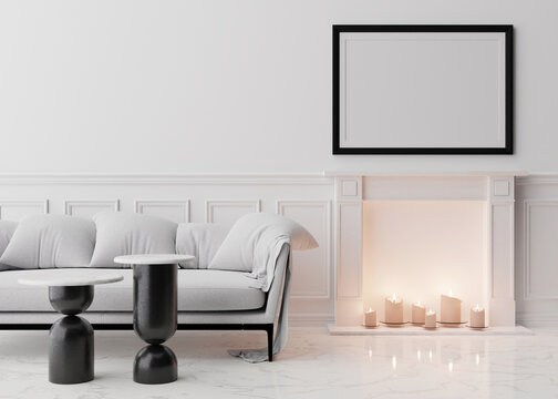 Empty black picture frame on white wall in modern living room. Mock up interior in classic style. Free space, copy space for your picture. White sofa, tables, fireplace with candles. 3D rendering.