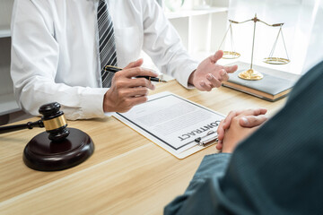 Male lawyer is meeting with businessman client to discuss consultation with litigation contract...