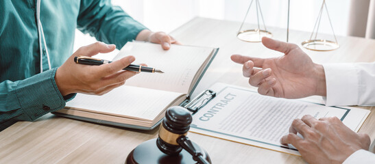 Male lawyer is meeting with businessman client to discuss consultation with litigation contract...