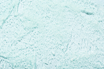 Fototapeta na wymiar Strokes of transparent facial gel cleanser on turquoise