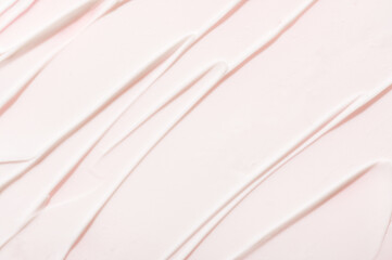 Smears pattern of anti allergic lotion on pink background