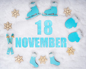 November 18th. Sports set with blue wooden skates, skis, sledges and snowflakes and a calendar date. Day 18 of month.