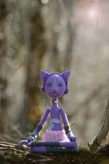 lilac cat sitting in the lotus position in the forest