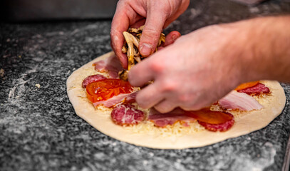 hand of chef baker making pizza at kitchen. The process of making pizza. cooking italian pizza
