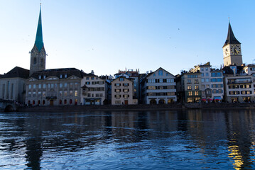 Fototapeta na wymiar Church tower of medieval protestant churches Women's minster and St. Peter at the old town of Zürich on a sunny winter day. Photo taken February 5th, 2022, Zurich, Switzerland.