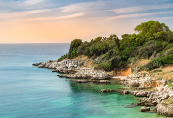 Rugged coastline near Kassiopi resort on Corfu island, Greece. Picturesque seashore with cliffs and...