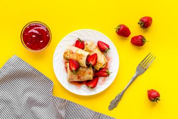 Hot french crepes with strawberry and berry sauce. Sweet dessert