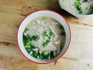 Hot chicken porridge in a bowl, ready to serve