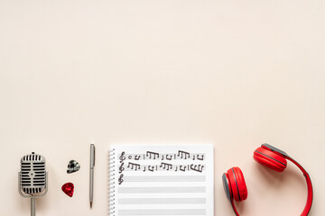 Handwritten music sheets and headphones, top view. Compose music concept