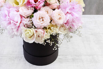 Bouquet with pink peonies, roses and yellow eustomas (lisianthus)