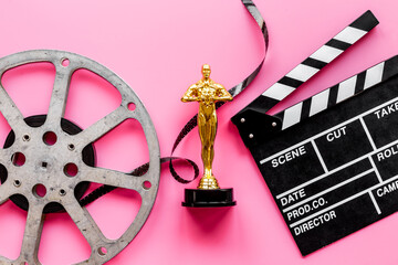 Film reel video tape with golden statue and movie clapper board