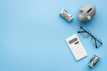 Money investments concept. Piggy bank with money and calculator