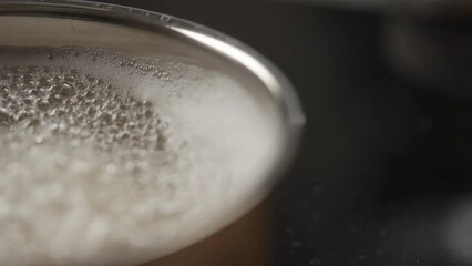 Slow motion pasta boiling in pot closeup focus pull