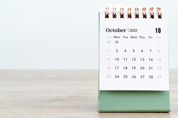 October 2022 desk calendar on wooden background. - obrazy, fototapety, plakaty