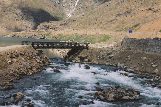 Black Bridge through the River Water Flow with Rocks in Gilgit Baltistan Highlands, Pakistan