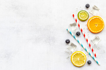 Slices citrus fruits and berries with with ice for making cocktail or juice