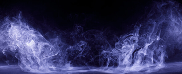 Abstract colored smoke moves on black background. Mystical swirling smoke rolling low across the...