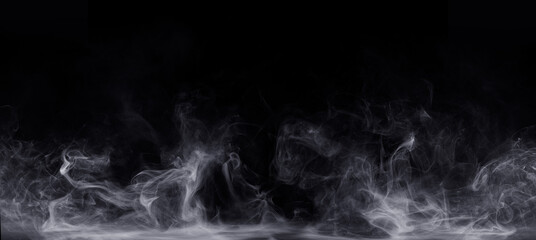 Abstract colored smoke moves on black background. Mystical swirling smoke rolling low across the...
