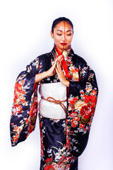 young pretty geisha in black kimono posing isolated on white background, asian ethno