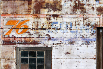 Old garage front with ghostsign from handpainted advert, Antelope, Oregon, USA