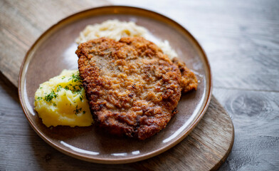 Pork breaded cutlet coated with breadcrumbs with mashed potatoes