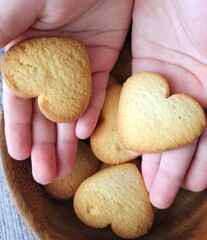 homemade cookies hearts in children's hands.  breakfast for a child