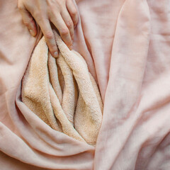 Pink soft fabric in the form of female labia and the woman's hand. One finger at the location of the clitoris. Illustration of sexual self-exploration, masturbation, relationships with vagina - obrazy, fototapety, plakaty
