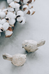 Two wooden birds on gray background. Spring decoration, easter elements.