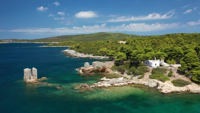 Aerial drone video of famous bay and small traditional village of Atsitsa covered in pine trees and natural sandy beaches, Skyros island, Sporades, Greece