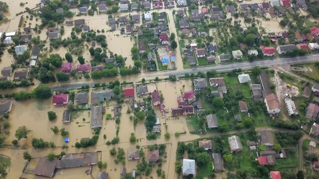 GALYCH, UKRAINE - JUNE 24, 2020: Flooded neighborhood street. Major flooding leaves city, underwater, entire community. Homes, houses overflowing water, insurance needed. helping people Aerial View