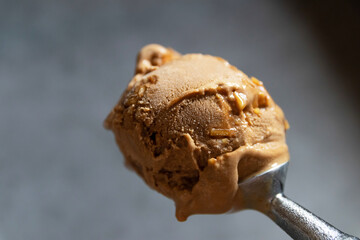 Ice cream scoop of coffee almond isolated on black background.