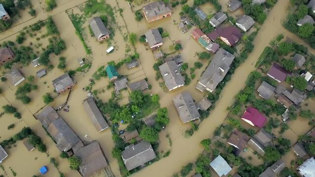 GALYCH, UKRAINE - JUNE 24, 2020: Flooded neighborhood street. Major flooding leaves city, underwater, entire community. Homes, houses overflowing water, insurance needed. helping people Aerial View