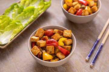 Tofu with Puy lentils, roasted peppers and vegetables: tomato, carrot, celery sticks. Vegan cuisine.