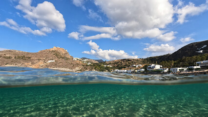 Fototapeta na wymiar Underwater split photo taken from beautiful emerald bay and beach of Kapsali overlooking famous castle of Kythira island, Ionian, Greece