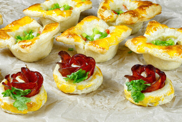fresh homemade pastries. puff pastry appetizers mix. rose-shaped pepperoni cake. pastry with salami. close up