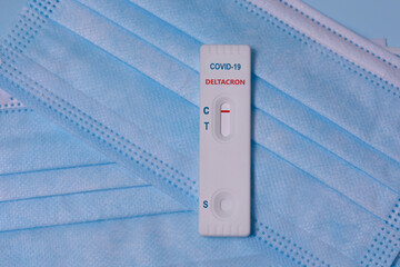 Express COVID-19 Deltacron, variant strain test Schnelltest on a medical masks. Deltacron is a...