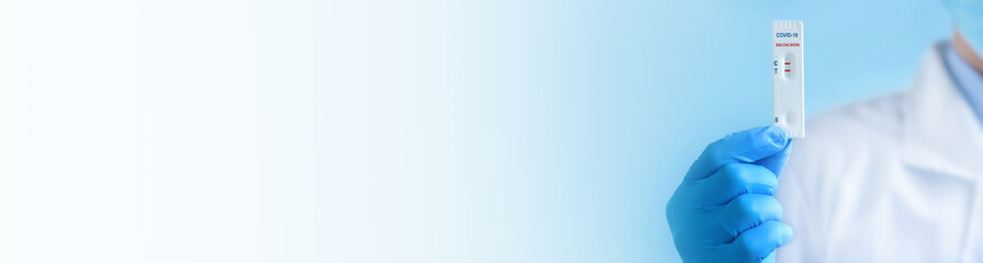 Doctor shows rapid laboratory test for COVID-19 Deltacron variant strain.Positive test...