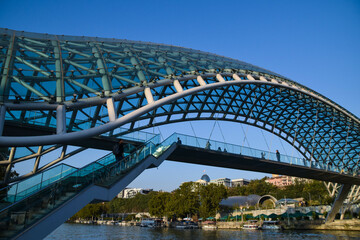 The Tbilisi Peace Bridge at day with blue sky in Tiblisi, Georgia