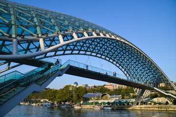 The Tbilisi Peace Bridge at day with blue sky in Tiblisi, Georgia